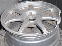 Broken and bent alloy wheel before repair